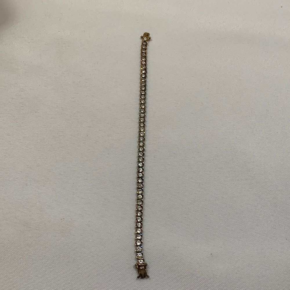 Goldtone Tennis bracelet with lobster clasp all stones intact.   925 SU
